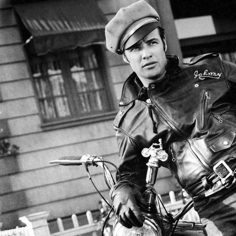 model wearing a leather jacket posing on bike