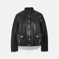 Black leather jacket with gold buttons on a white background