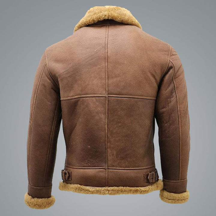 Brown leather jacket with fur trim on a gray background