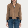 Brown suede jacket with black cuffs and collar worn by a person on a white background