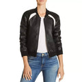 Black leather jacket with white accents worn by a person on a white background