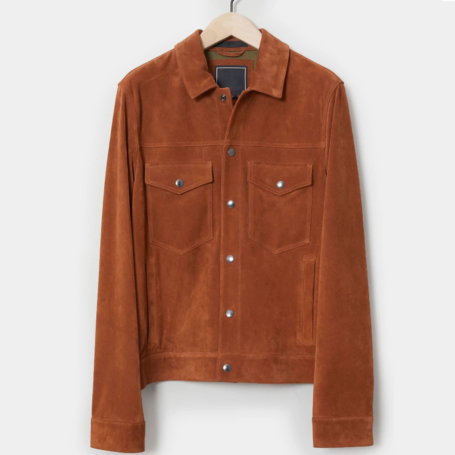 Brown suede jacket on a hanger against a white background