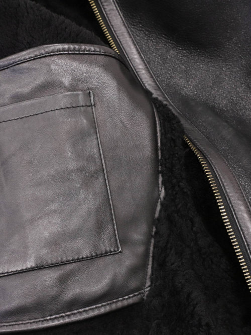 Interior patch pocket inside black shearling aviator jacket