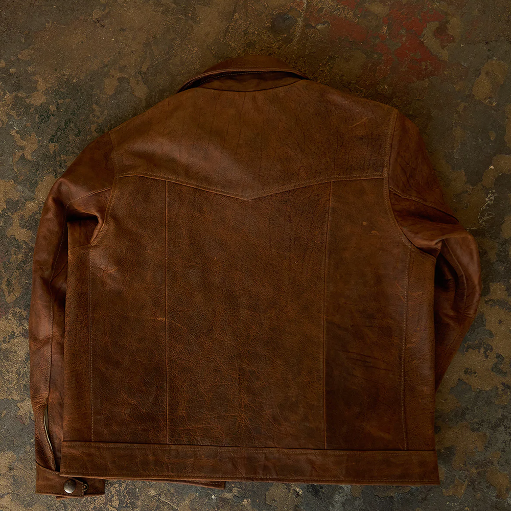 Brown leather jacket on a textured, multicolored background