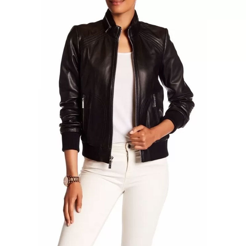 Person wearing a black leather jacket and white pants on a white background