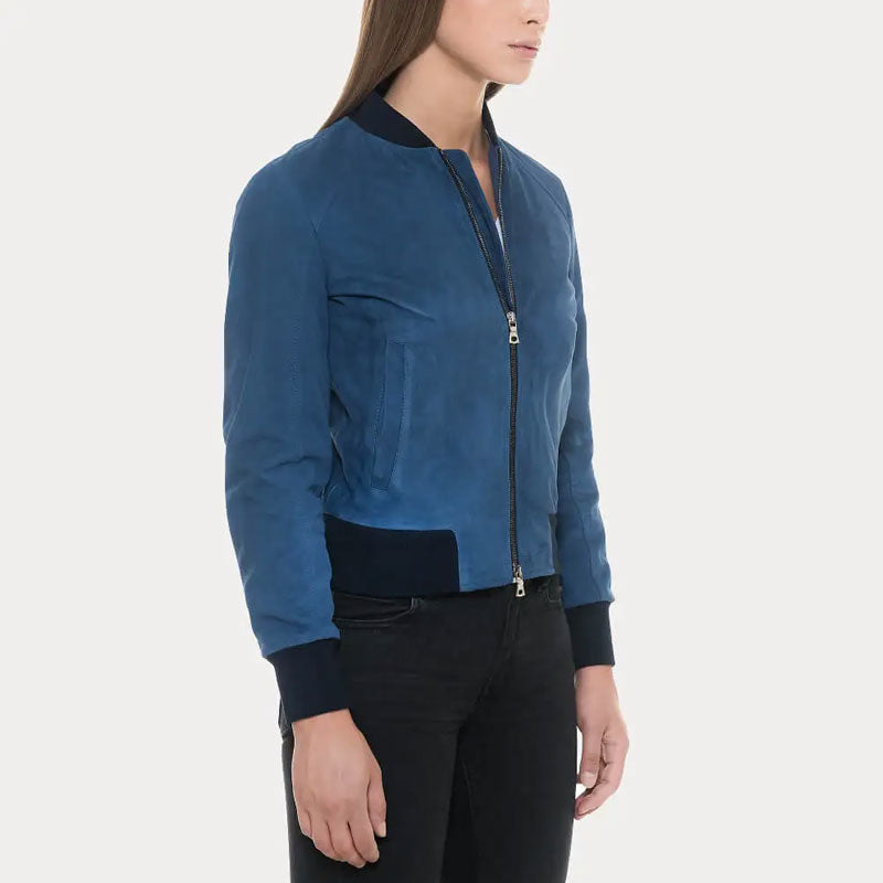 Person wearing a blue bomber jacket with black accents on a white background
