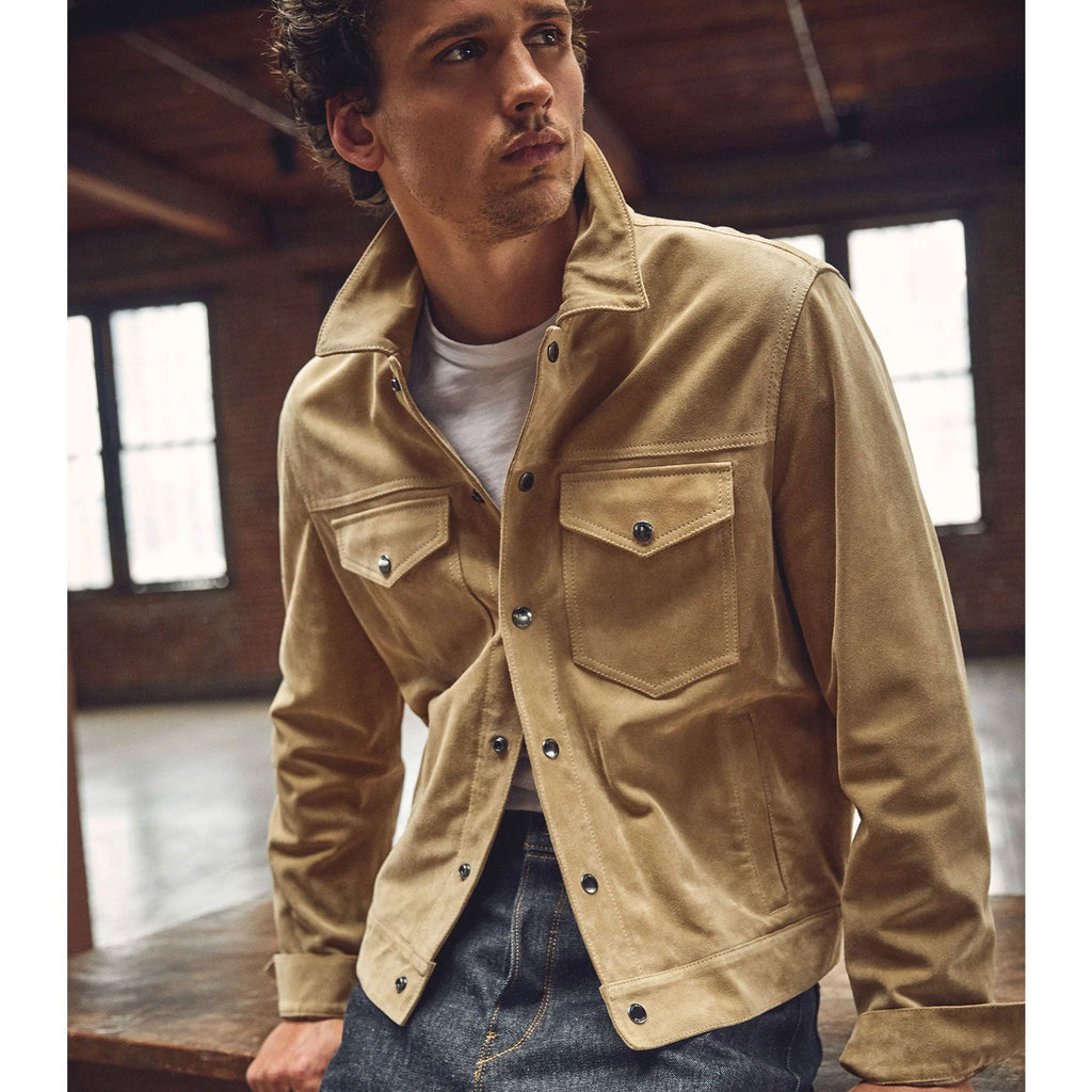 Man wearing a beige jacket in an indoor setting