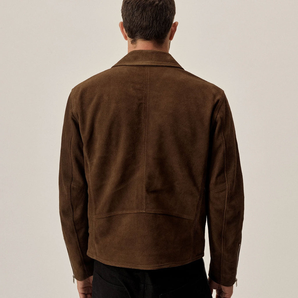 Man wearing a brown suede jacket against a plain background