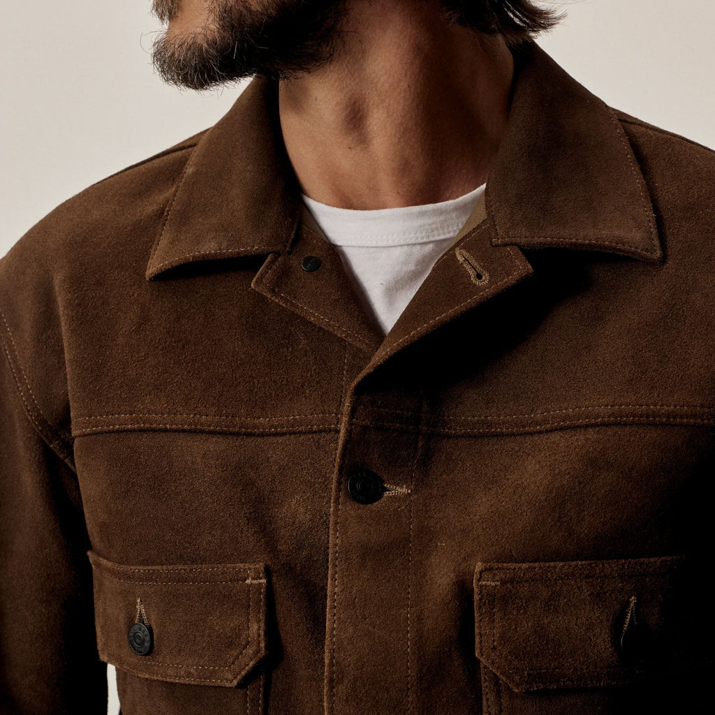 Brown jacket worn by a person with a neutral background