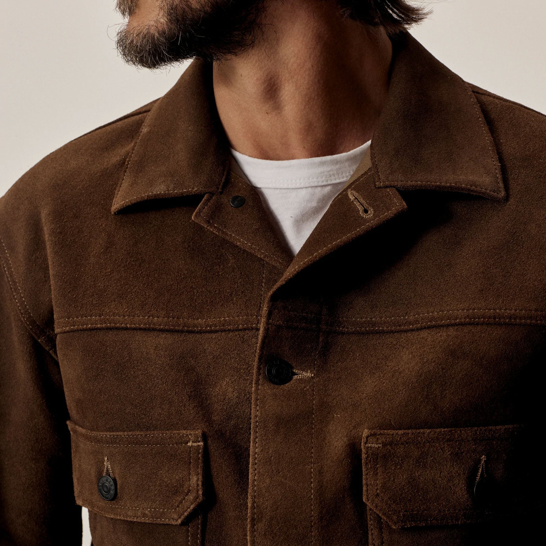 Brown jacket worn by a person with a neutral background