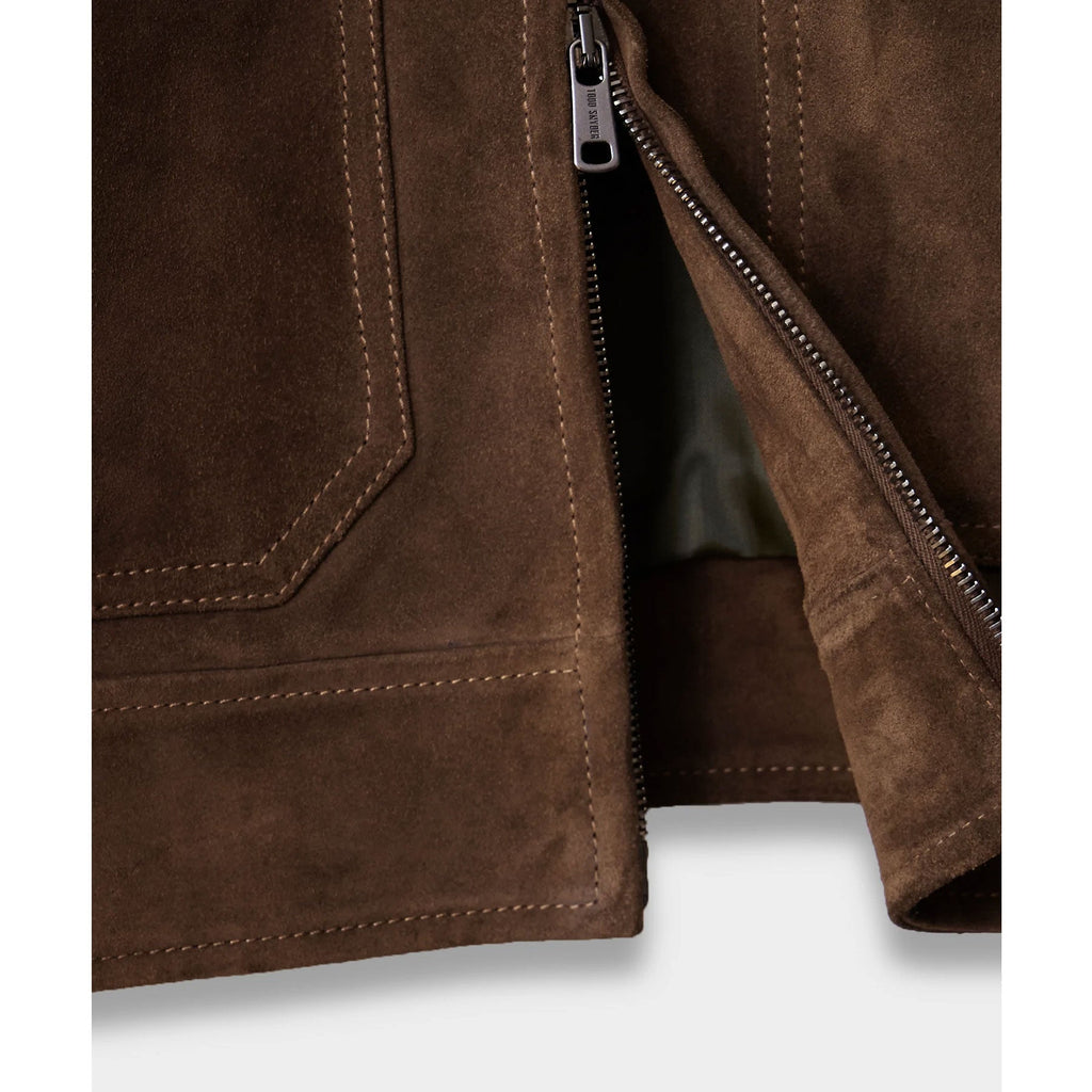 Close-up of a brown leather jacket with a zipper on a white background