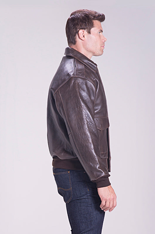 Man wearing a brown leather jacket on a light gray background