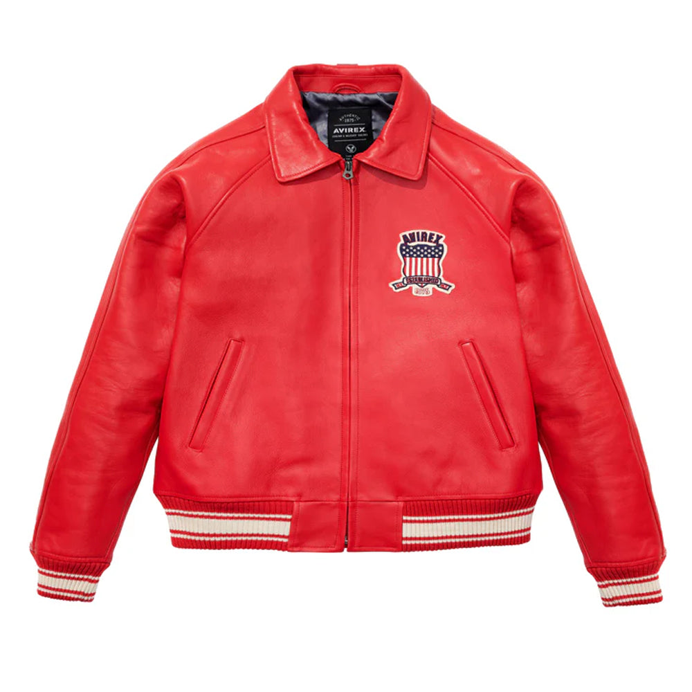 A red leather bomber jacket with a zip-up front, ribbed knit collar, cuffs, and hem, featuring a 'ANIBEL' American flag patch on the left chest, displayed on a clean white background.