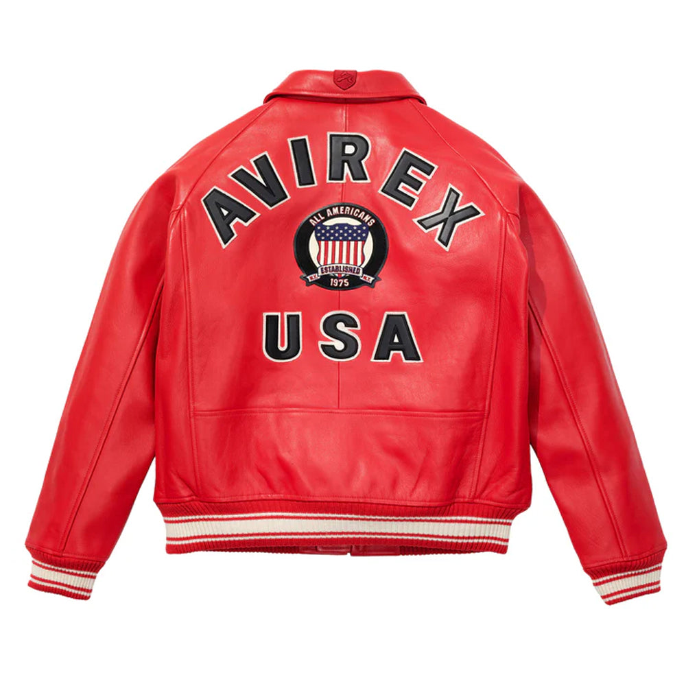 A red leather jacket shown from the back, featuring 'AVIREX USA' and a circular American flag emblem printed in black, white, and blue on the back. The jacket has ribbed collar, cuffs, and hem with white and red stripes, set against a plain white background.