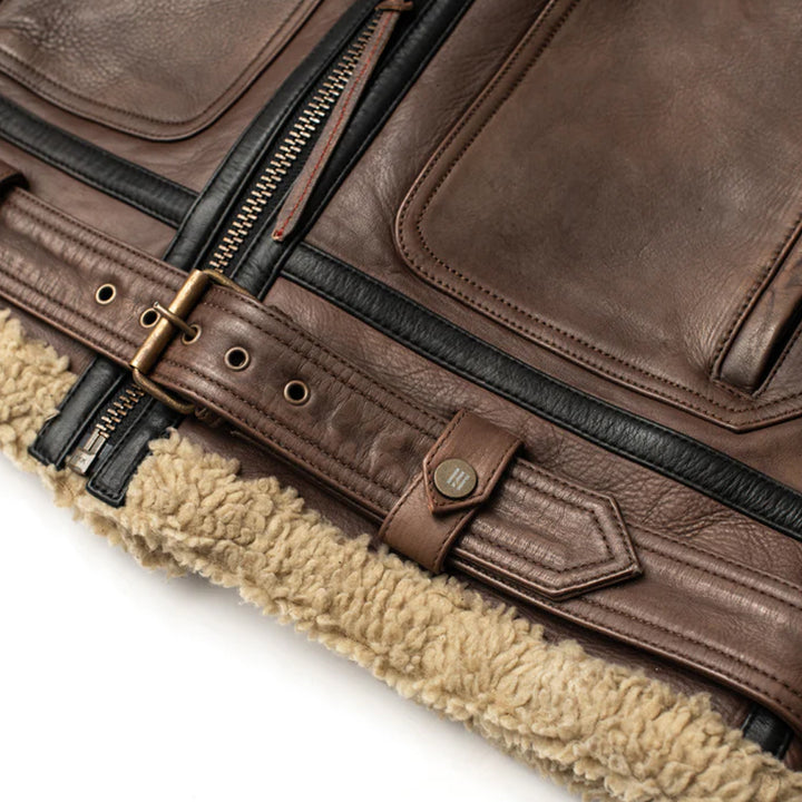 Close-up of a brown leather bag with shearling lining on a white background