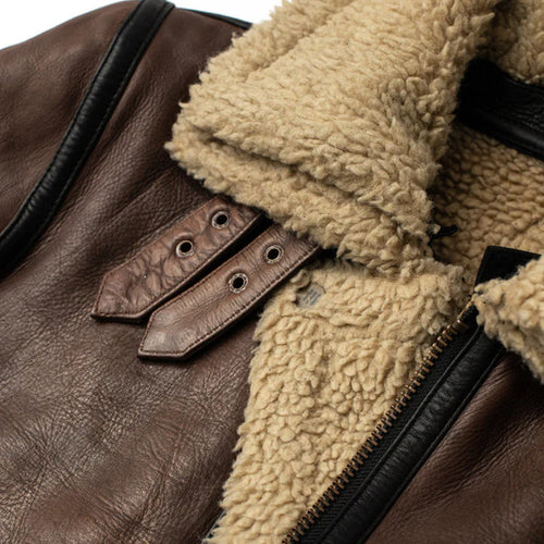 Close-up of a brown leather jacket with beige fur lining