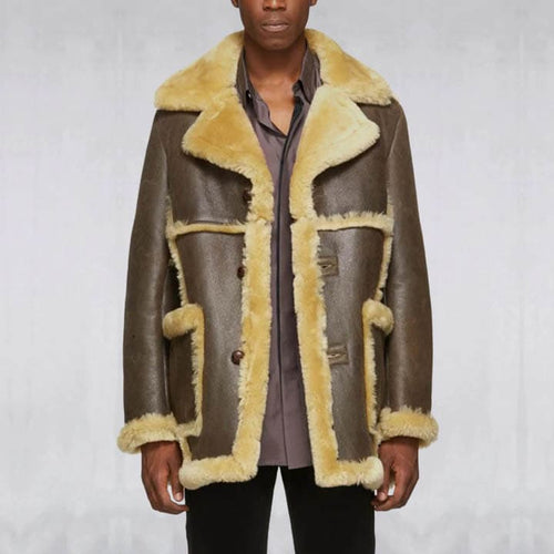 Man wearing a brown leather coat with yellow fur trim on a plain background