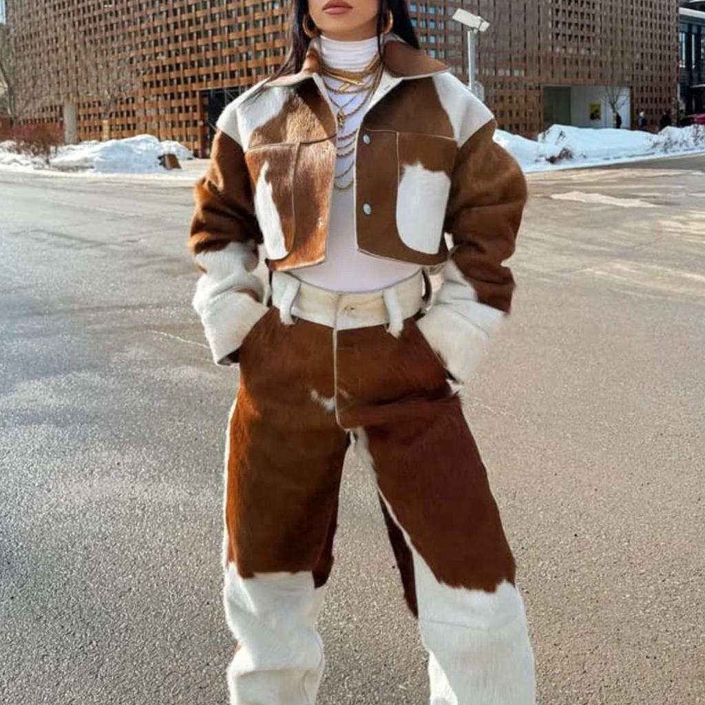 Person wearing a brown and white outfit standing on a street.