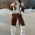 Person wearing a brown and white outfit in an urban setting with snow on the ground.