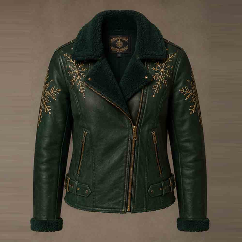A dark green faux leather motorcycle jacket with a black shearling collar and cuffs, decorated with gold snowflake embroidery on the chest and sleeves, shown against a neutral brown background.