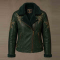A dark green faux leather motorcycle jacket with a black shearling collar and cuffs, decorated with gold snowflake embroidery on the chest and sleeves, shown against a neutral brown background.