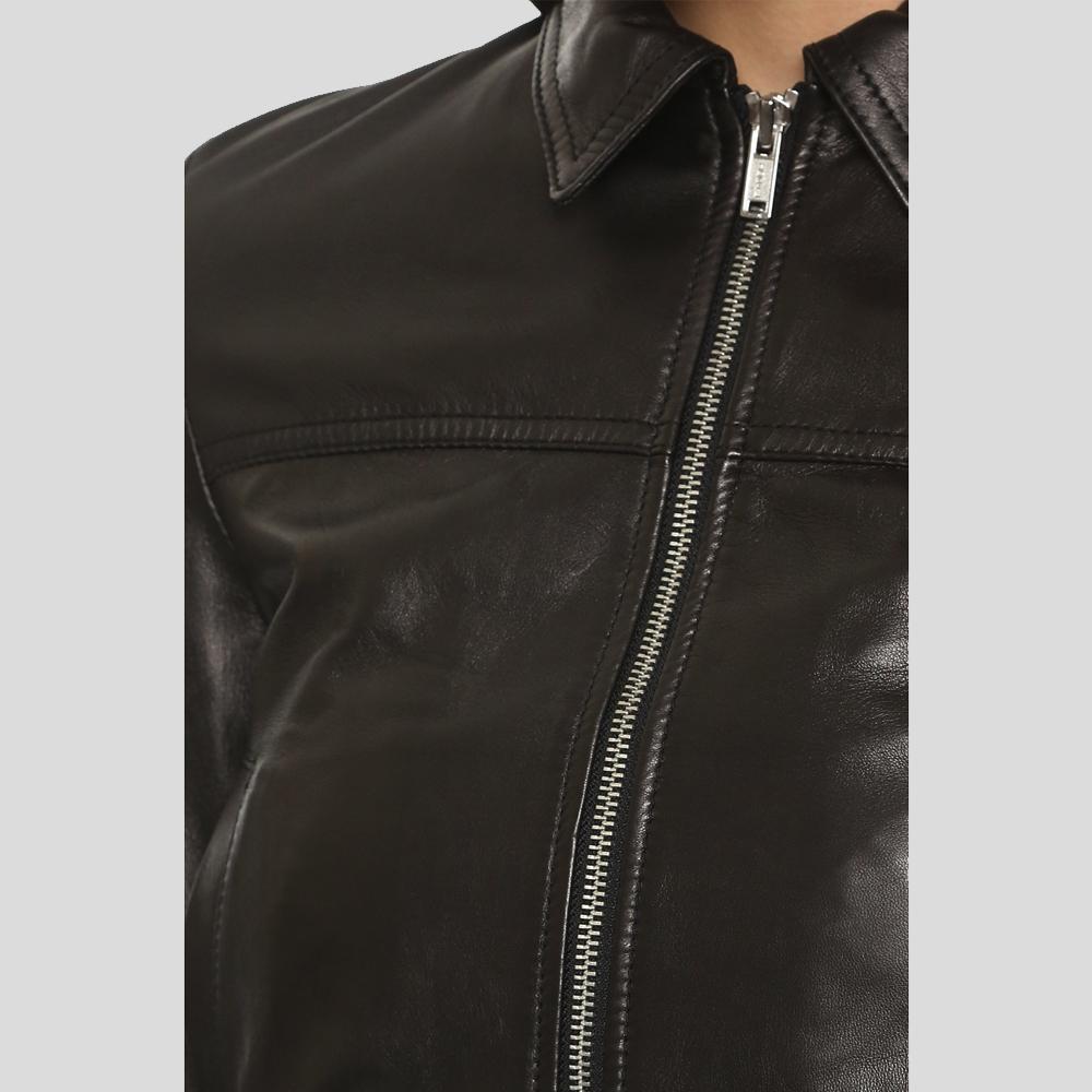 Close-up of a black leather jacket with a zipper on a light gray background