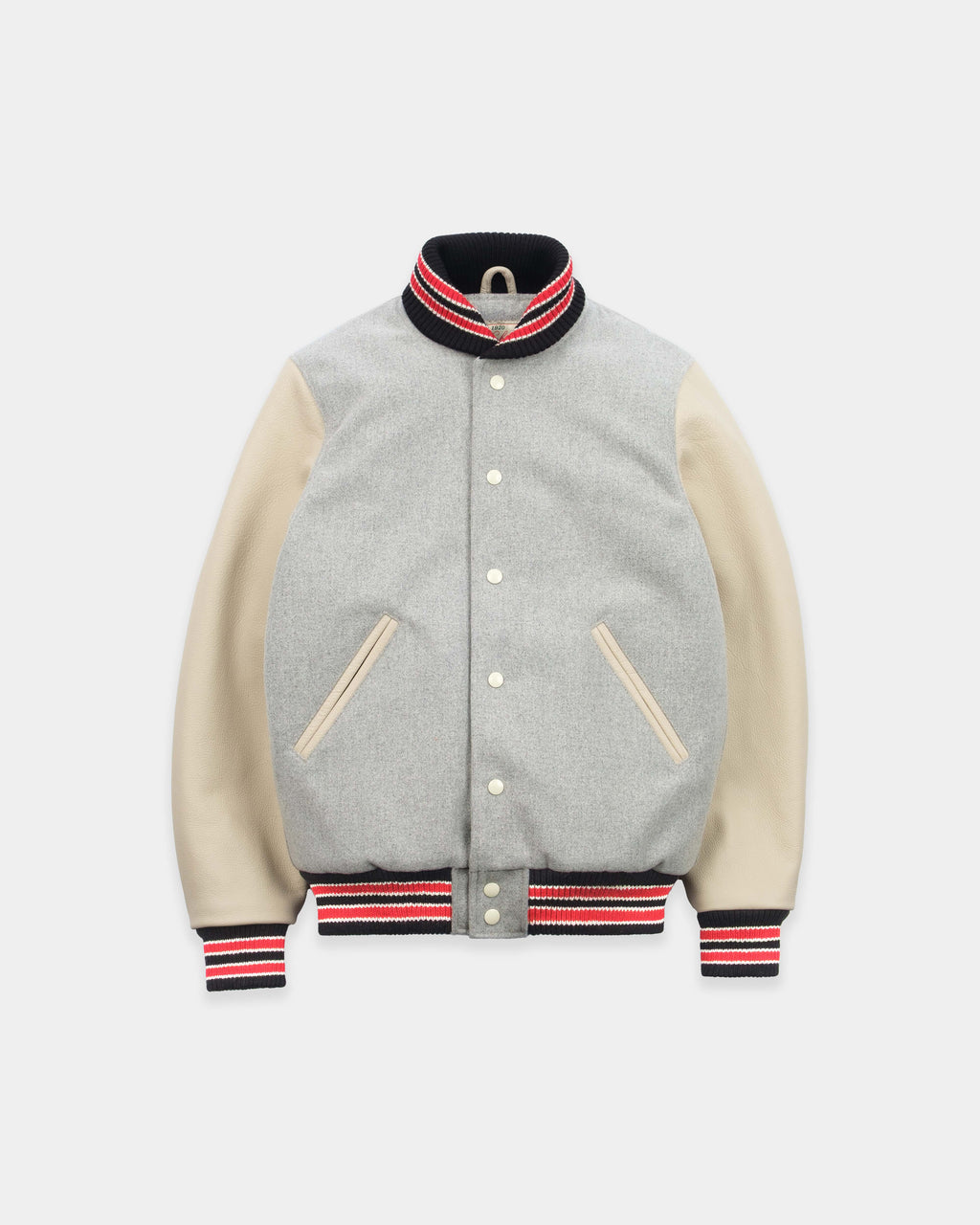 A varsity-style jacket with a light gray heathered body, beige sleeves, and black, red, and white striped ribbed trim on the collar, cuffs, and hem.
