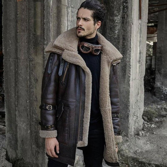 Man wearing a vintage-style leather coat with fur collar in an industrial setting