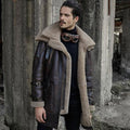 Man wearing a vintage-style leather coat with fur collar in an industrial setting