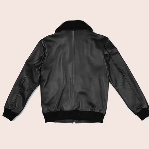 Black leather bomber jacket on a beige background