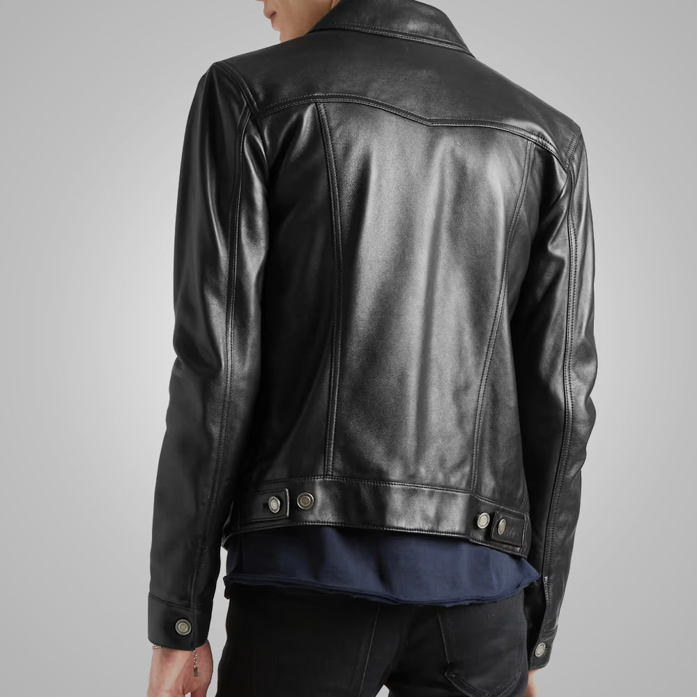 Black leather jacket worn by a person on a gray background