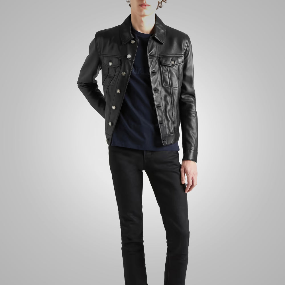 Person wearing a black leather jacket and dark jeans on a gray background