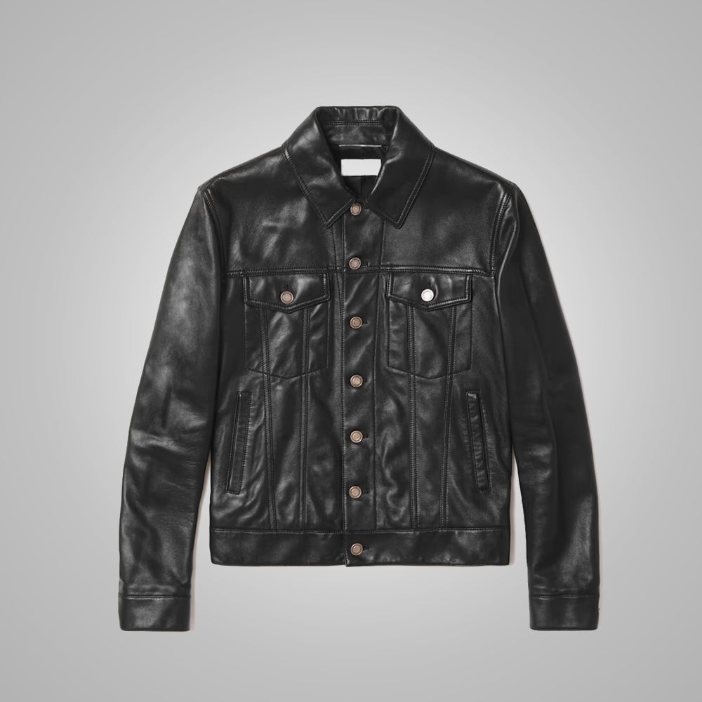 A black leather trucker jacket with a button-up front, two chest flap pockets, and two lower side pockets, displayed flat against a neutral gray background.
