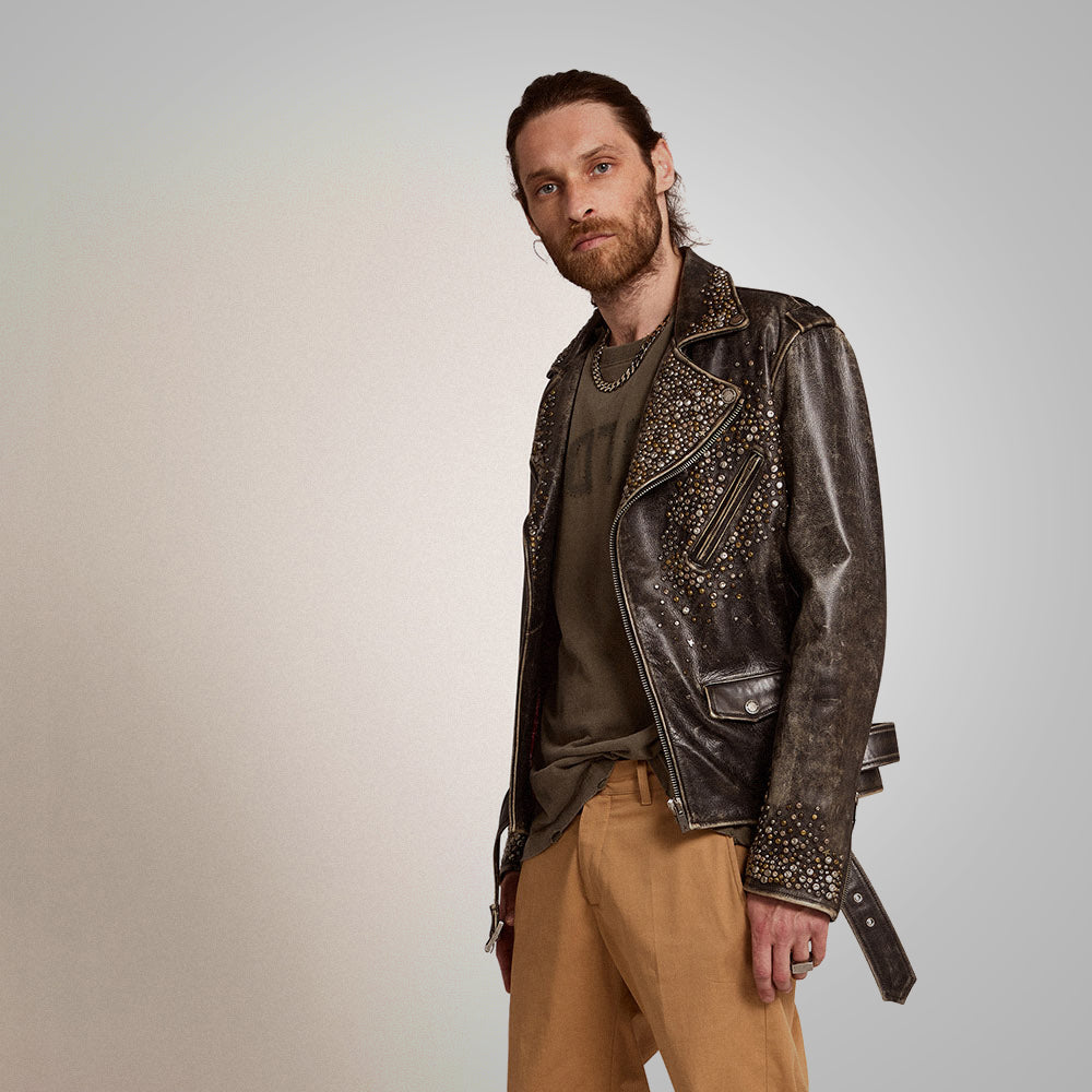 Man wearing a studded leather jacket on a plain background