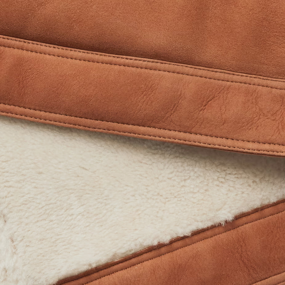 Close-up of brown leather and white fleece material