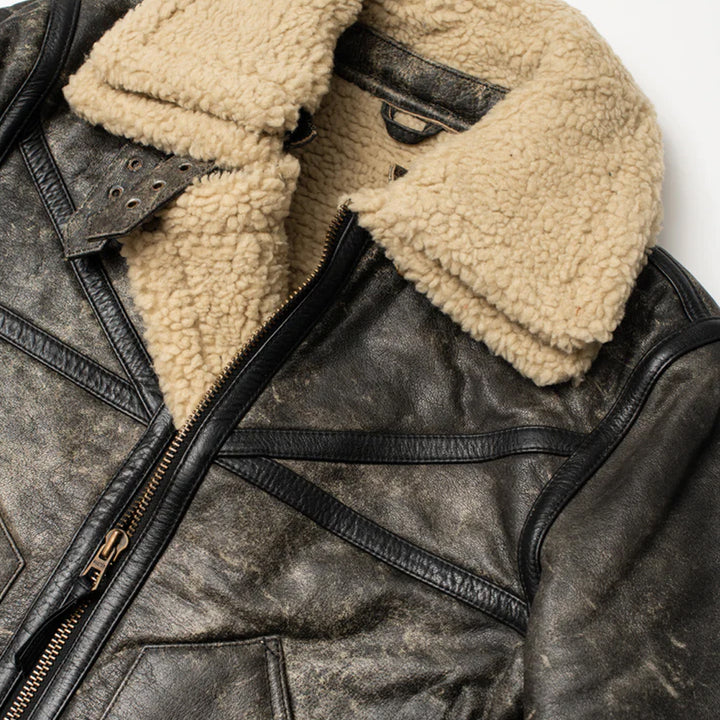 Close-up of a leather jacket with beige shearling lining on a white background