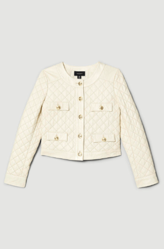 An off-white quilted jacket with gold-tone buttons and flap pockets, displayed flat against a light gray background.