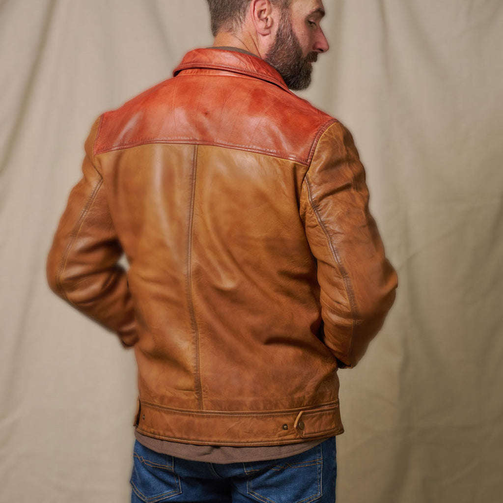 Man wearing a brown leather jacket against a beige background