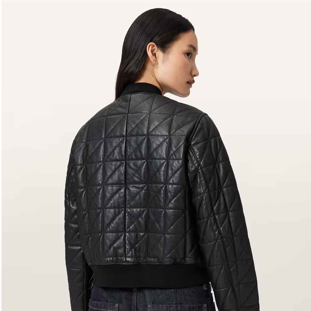 A model shown from the back wearing a black quilted leather jacket with a diamond pattern, set against a plain off-white background.