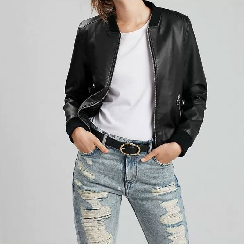 Person wearing a black leather jacket, white shirt, and ripped jeans on a light gray background