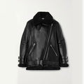 A black leather aviator-style jacket with a plush black shearling collar, matching shearling lining at the hem and cuffs, and silver-tone hardware, shown against a plain light background.