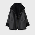 Black leather jacket with fur trim on a light gray background