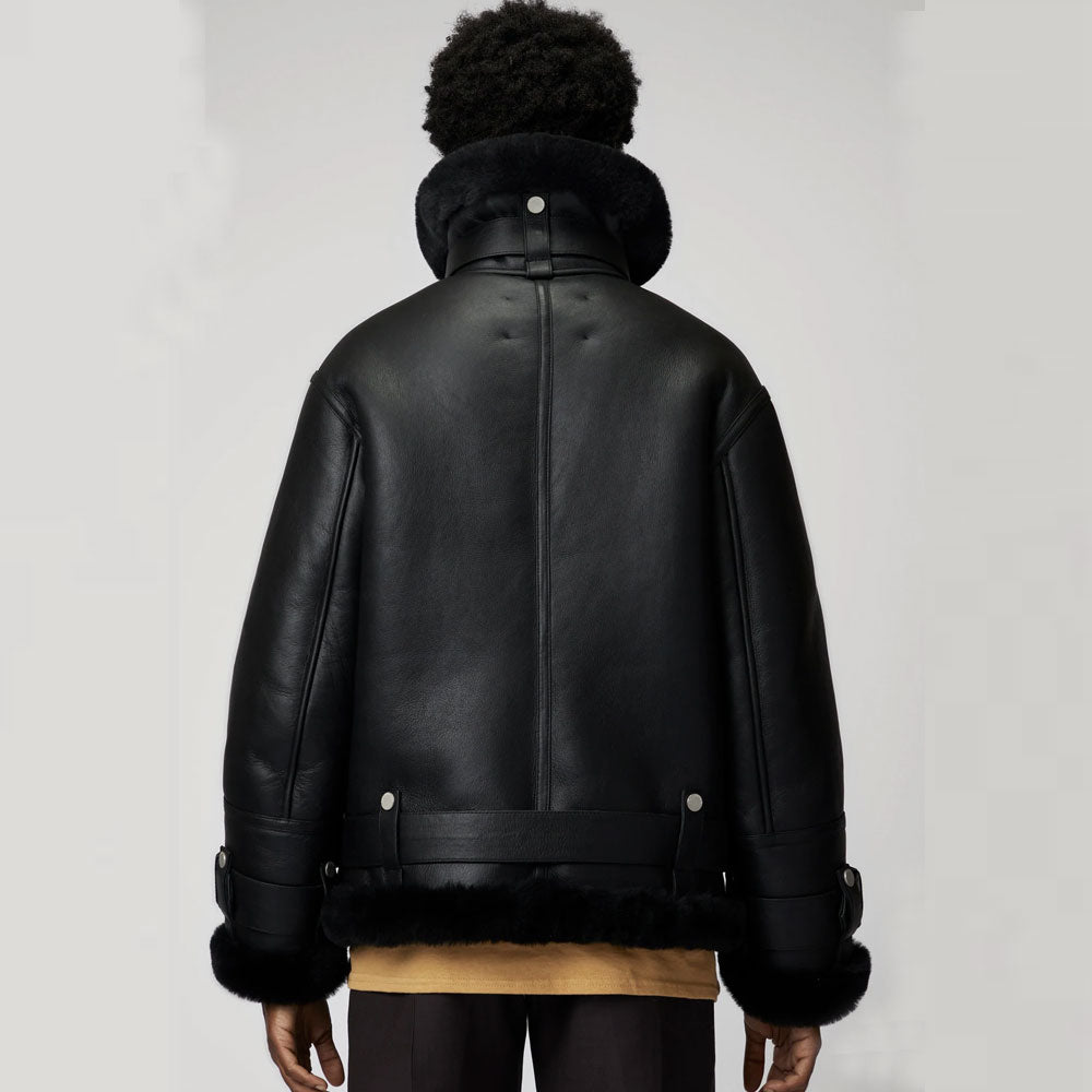 Black leather jacket with fur trim on a plain background