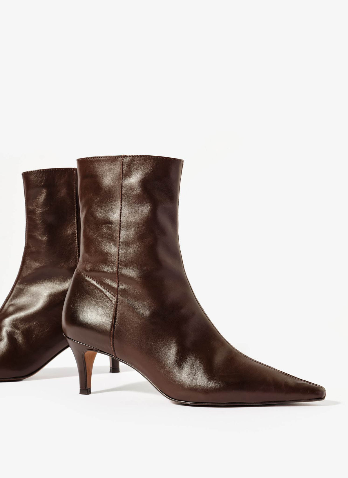 Pair of brown leather ankle boots on a white background