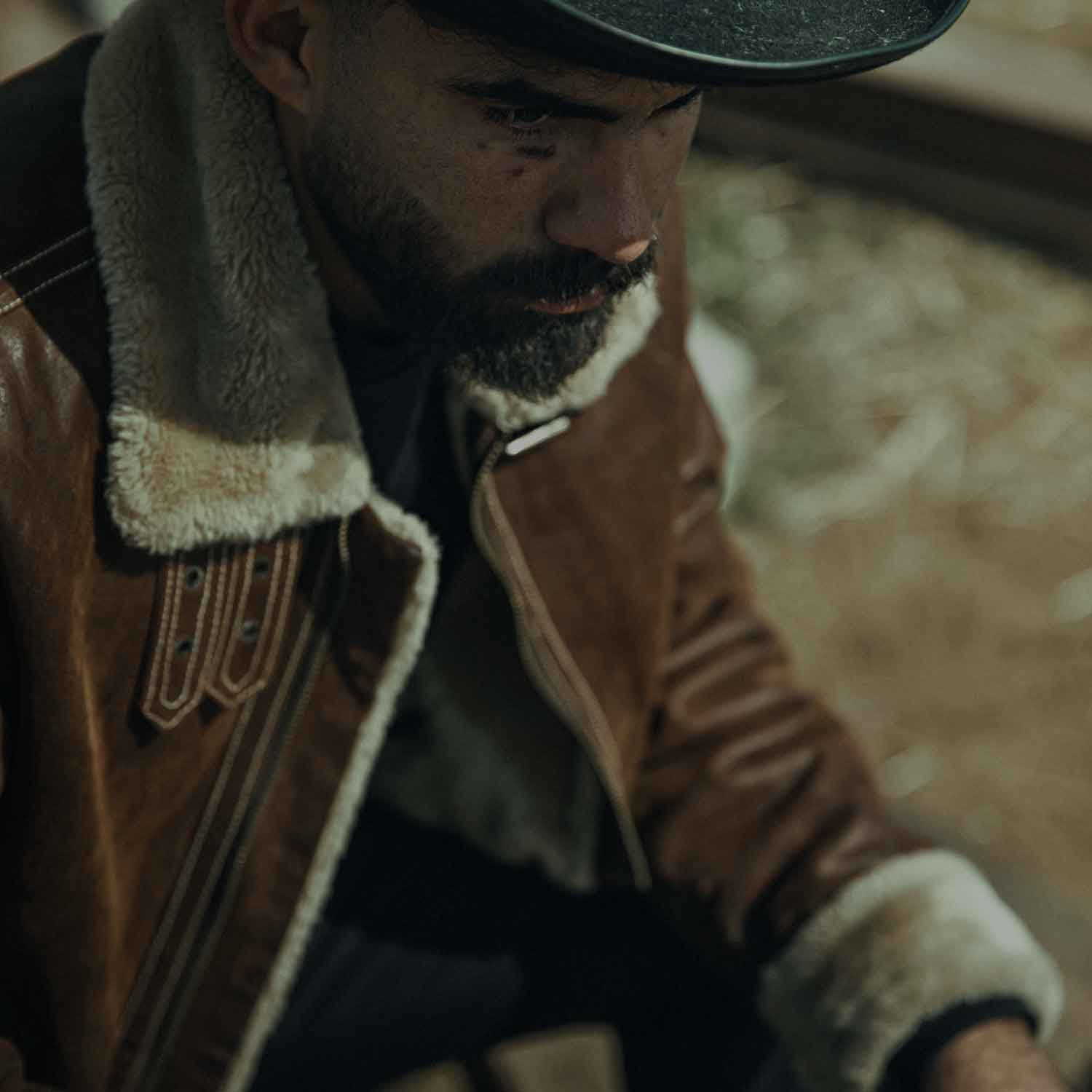 Men in cowboy hat wearing shearling jacket