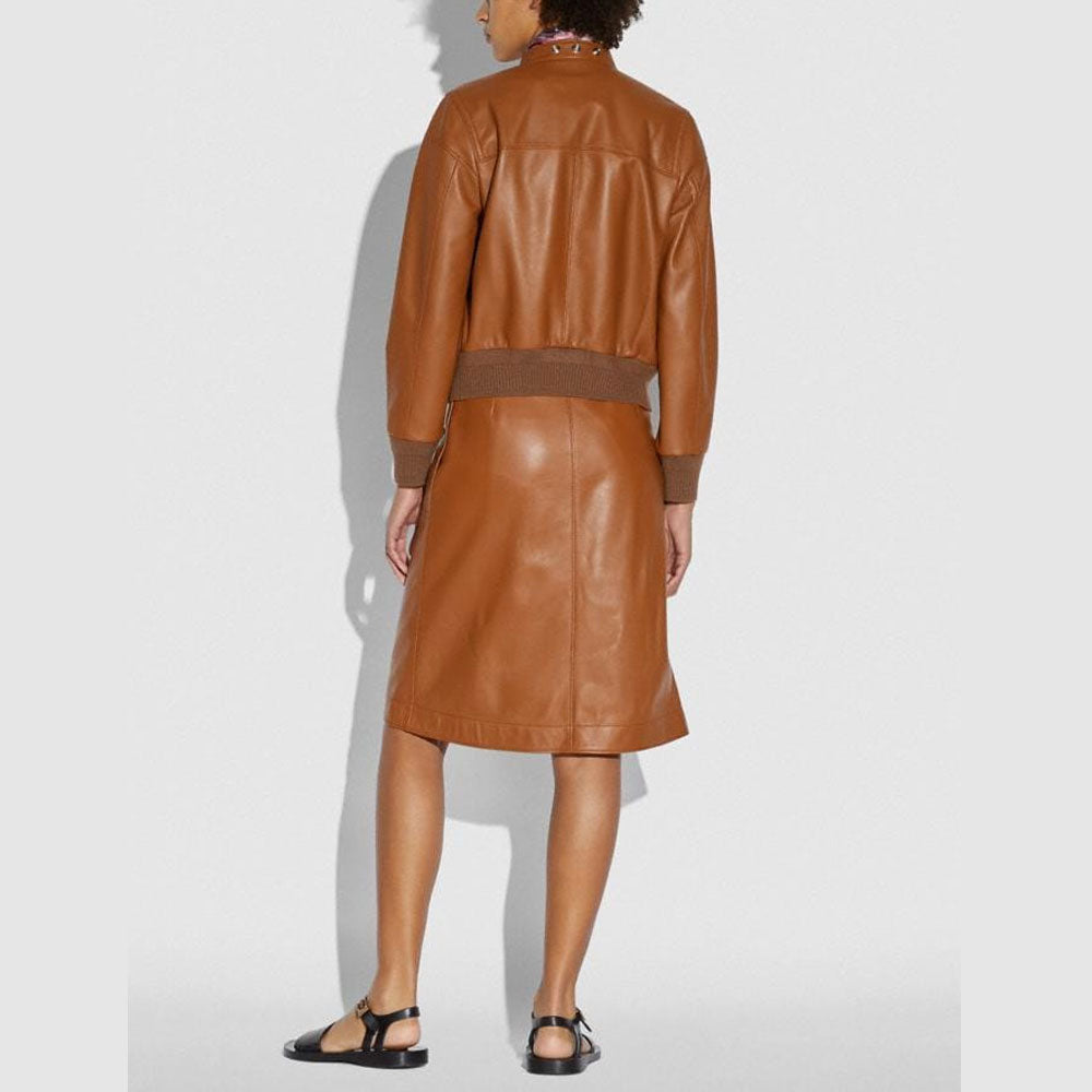 Person wearing a brown leather outfit on a white background