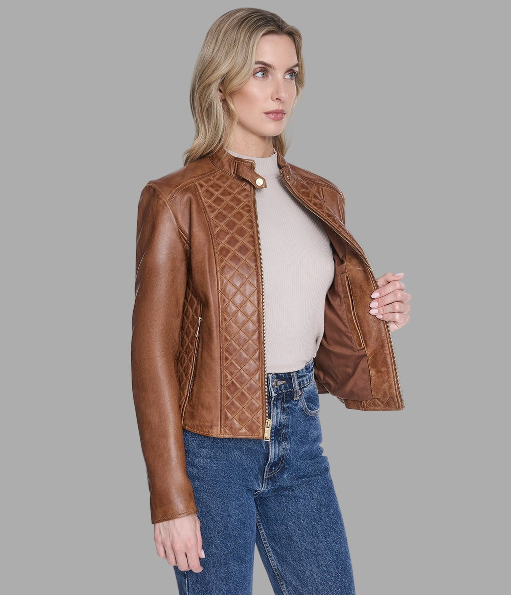 Woman wearing a brown quilted leather jacket on a gray background