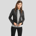 Woman wearing a black leather jacket on a gray background