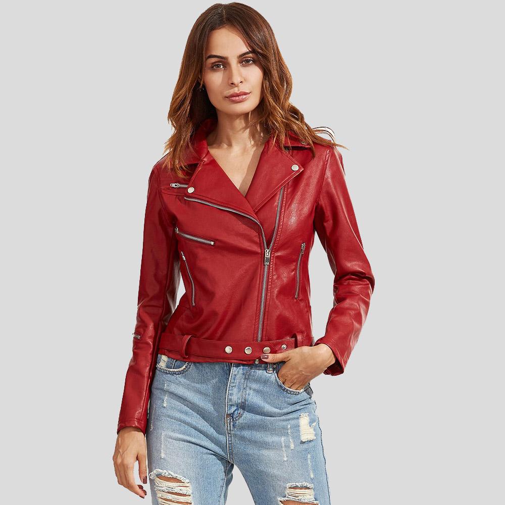 Woman wearing a red leather jacket and ripped jeans on a light gray background