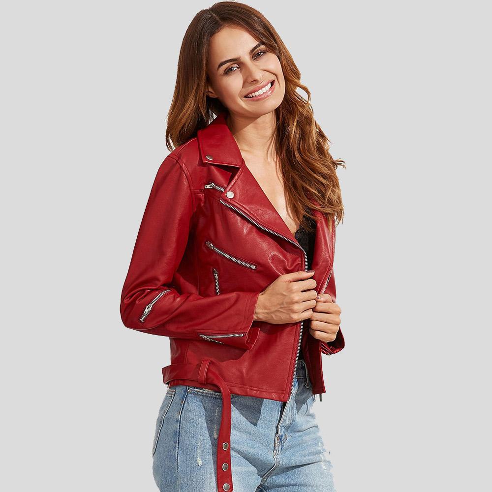 Woman wearing a red leather jacket and blue jeans on a light gray background